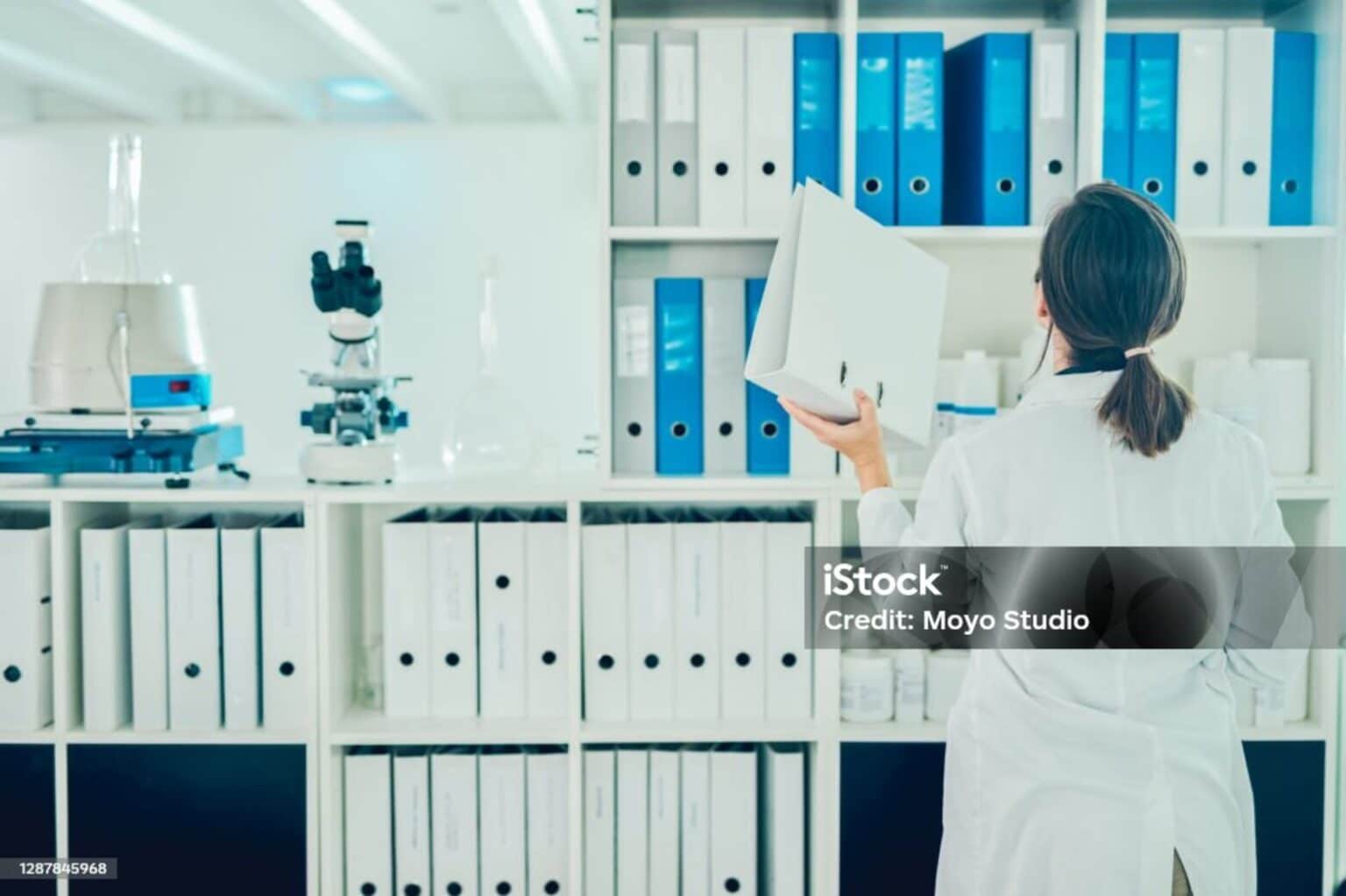 Shot of a scientist going through files while conducting research in a laboratory